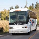 Badder Bus driver happily drives down a country road