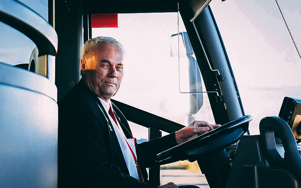 Badder Bus driver sitting behind the wheel happily awaiting passengers