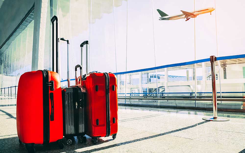 Family's luggage beside the airport window