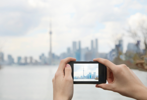 Cell phone taking a picture of the Toronto Skyline